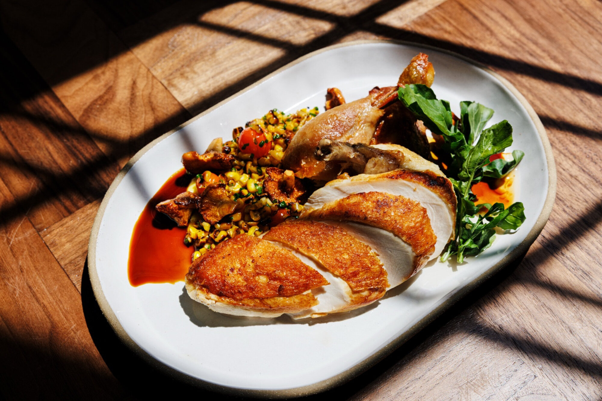 Wood-fired half-chicken with corn puree and chanterelles