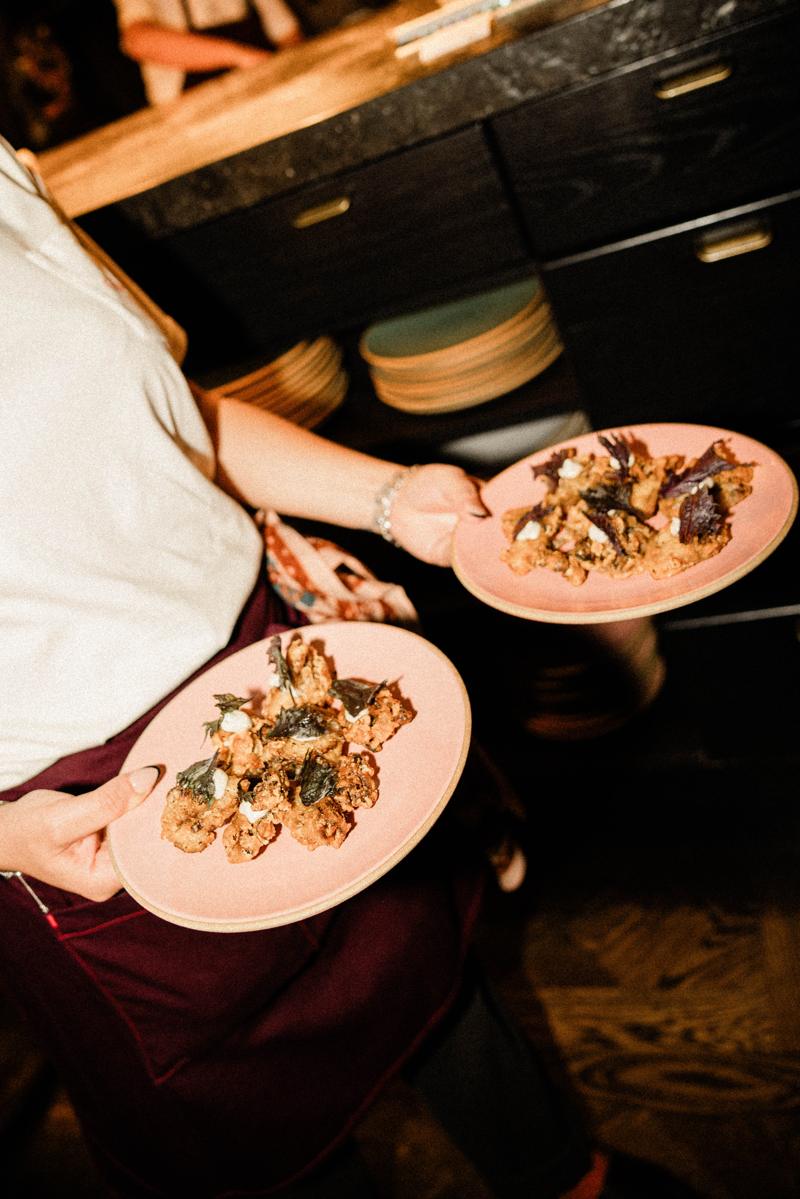 A server carrying plates to the dining room