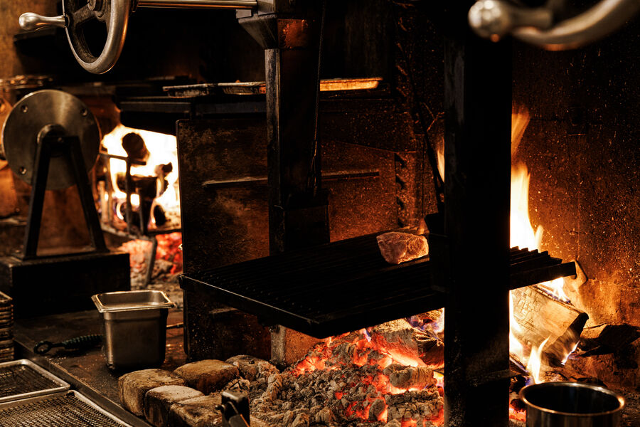 embers and open flame in the wood-fired grill
